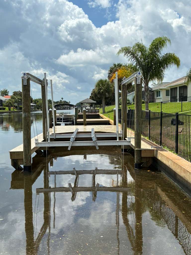 Boat lift installation on a residential canal dock